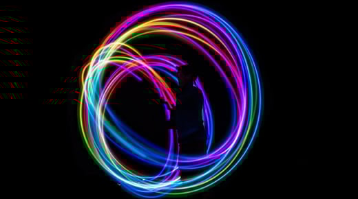 A silhouette of a person stood in the centre of a circle of lights